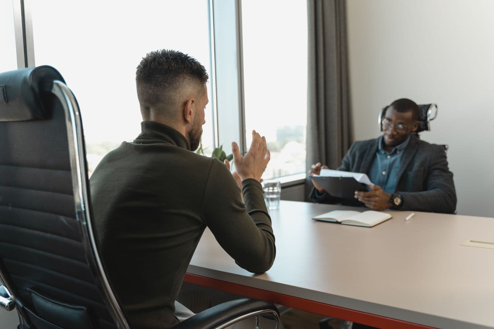 Two colleagues discussing plans in an office